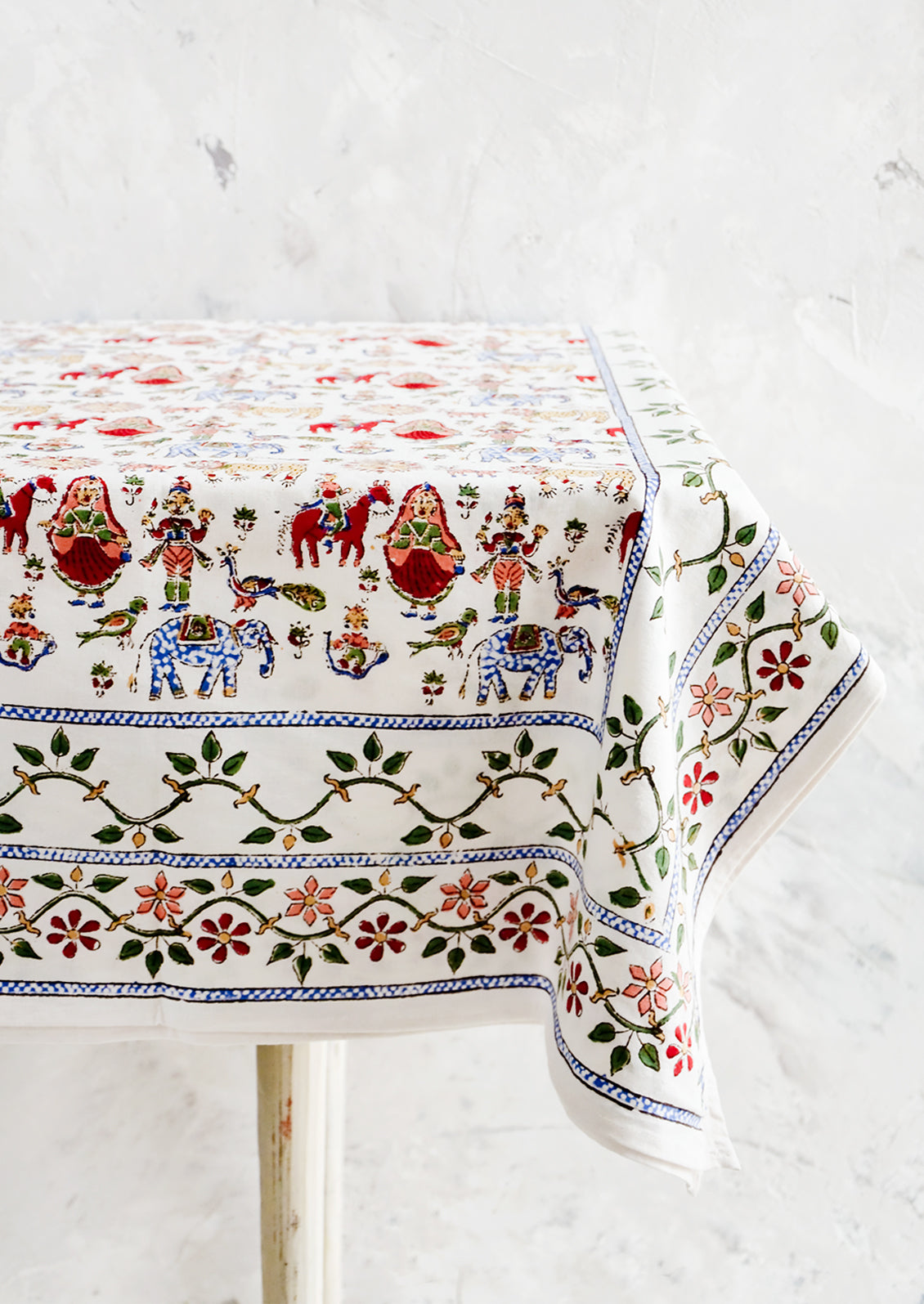 White cotton tablecloth with multicolor, block printed folk carnival themed print