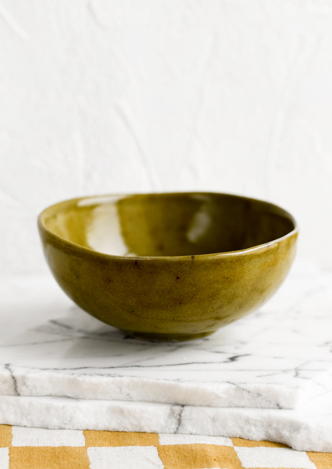 A small ceramic bowl in mossy green glaze.