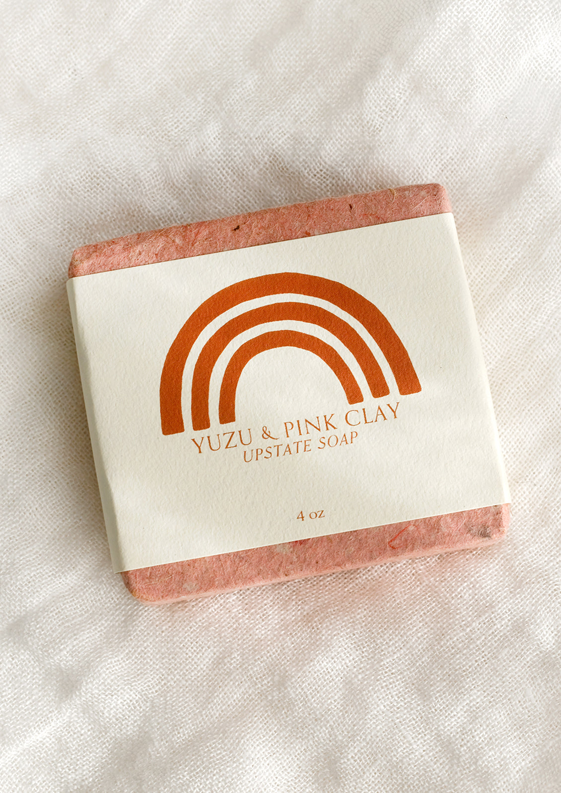 A bar of yuzu and pink clay soap.