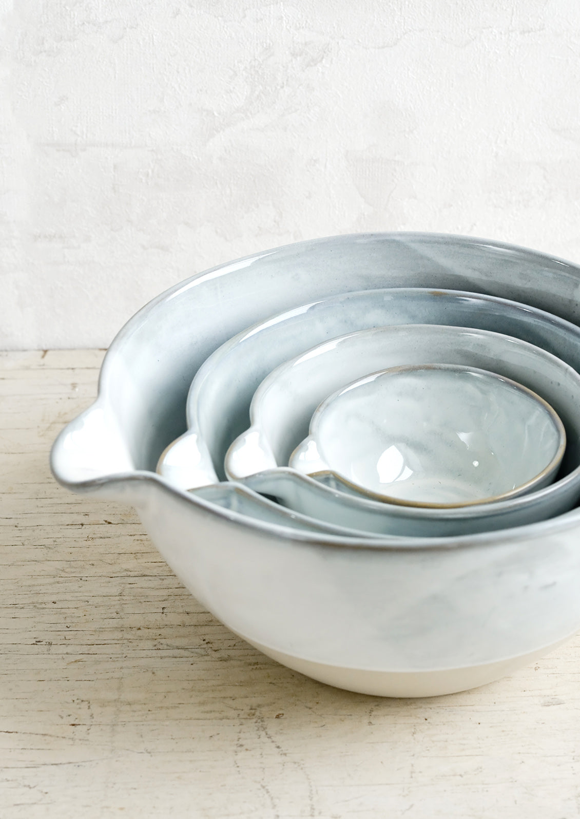 Four nesting ceramic bowls with pouring spouts.