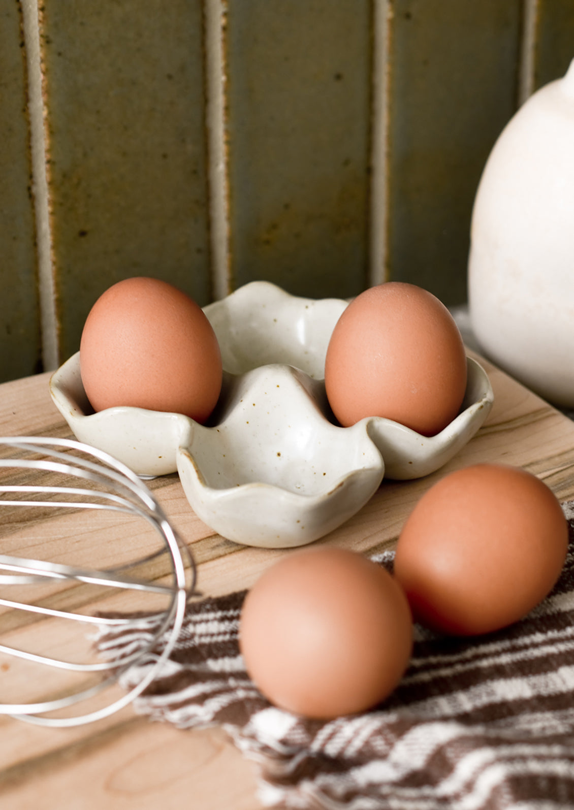 A ceramic egg holder on a kitchen counter.