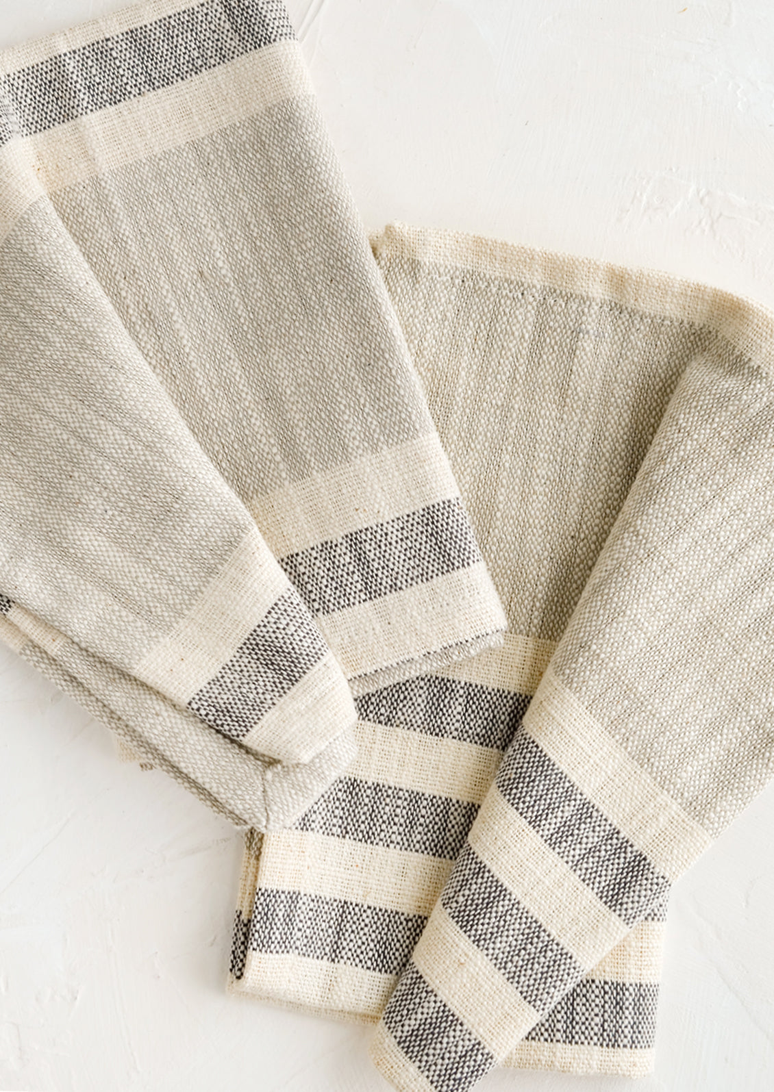 A pair of folded napkins in chambray stripes.