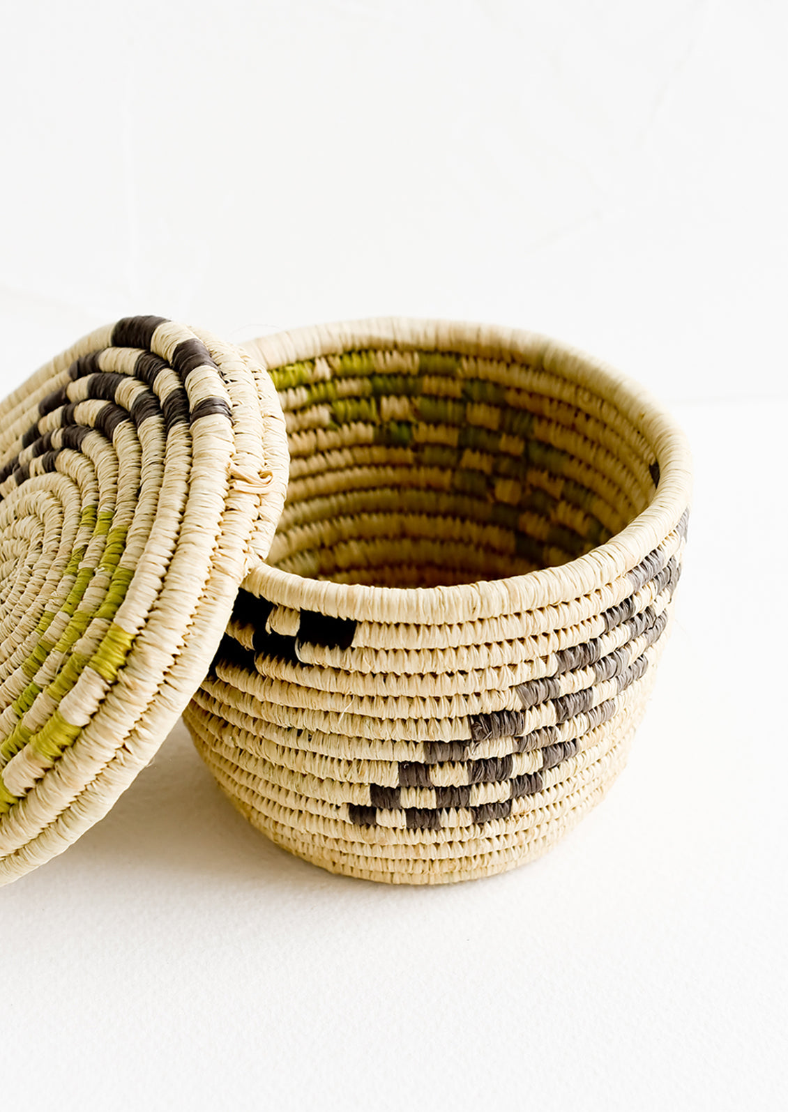 Small raffia baskets in woven checker print.