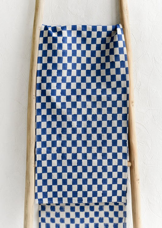 A linen table runner in cobalt checker print.