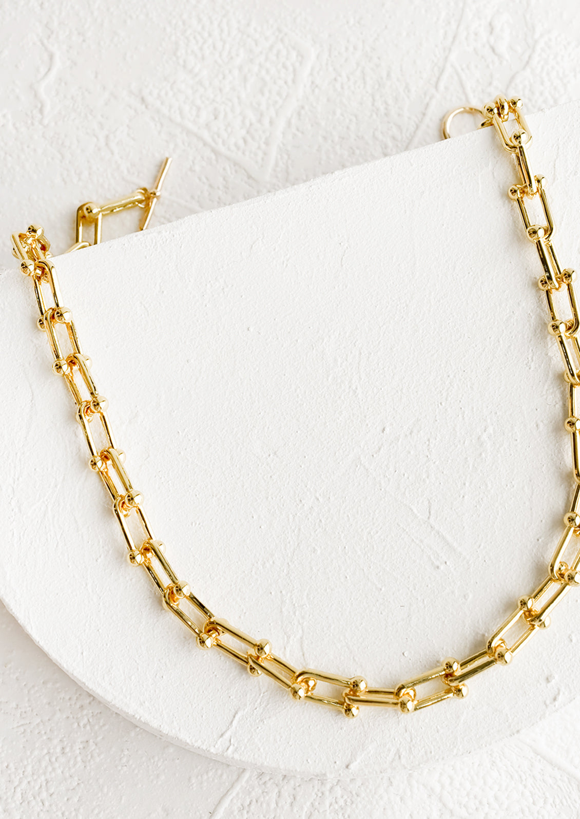 A chunky chainlink necklace in gold.