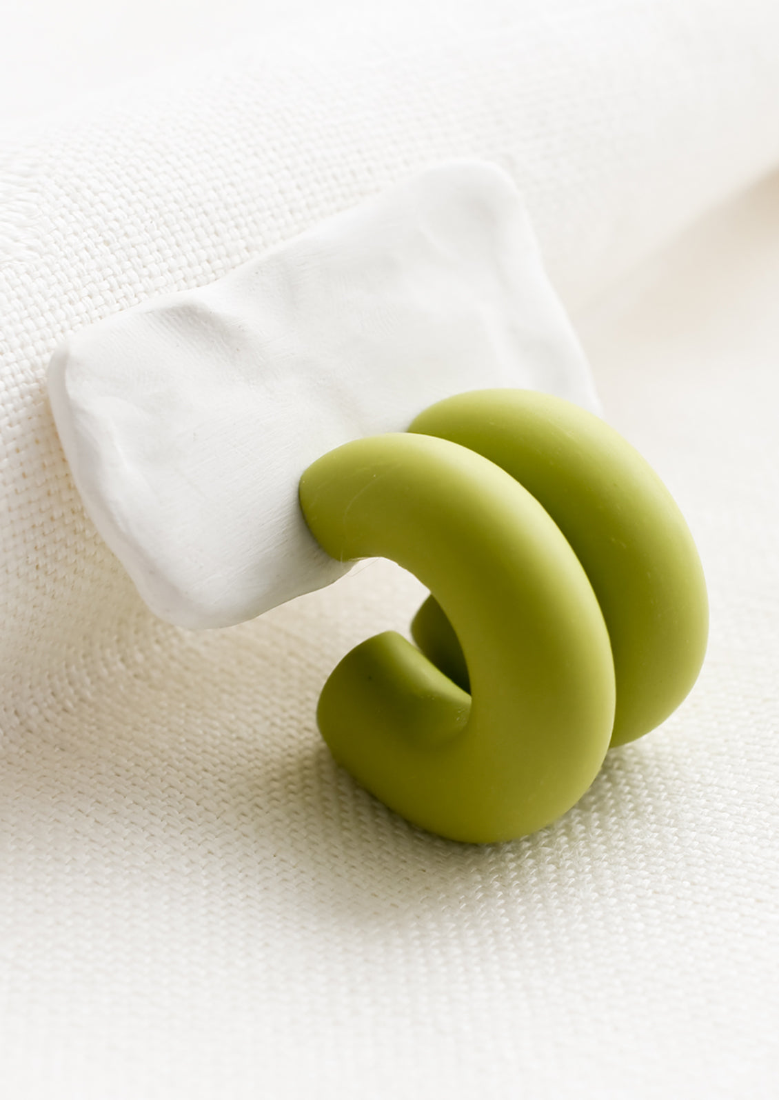 A pair of polymer clay hoop earrings in green apple.