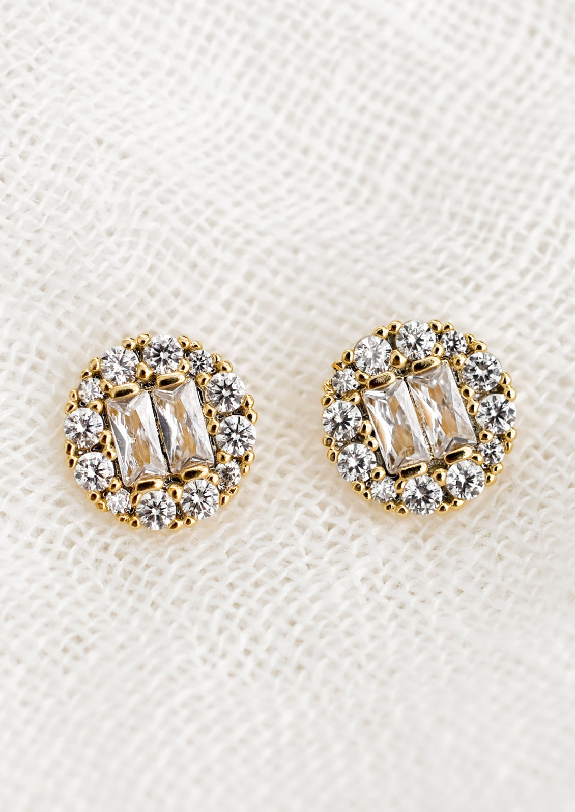 A pair of circle shaped stud earrings with baguette pave crystals.