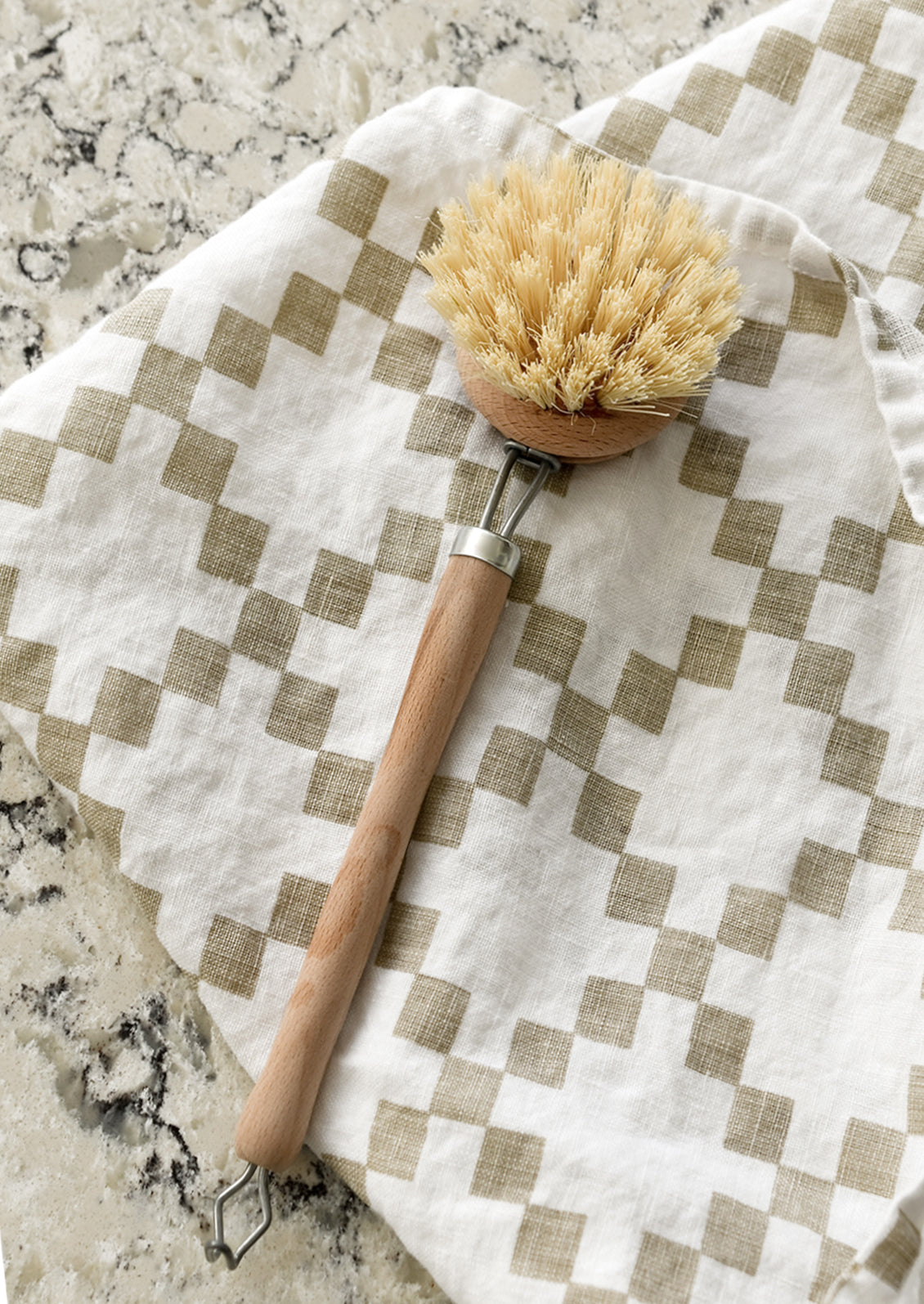 A beech wood cleaning brush on a kitchen counter.