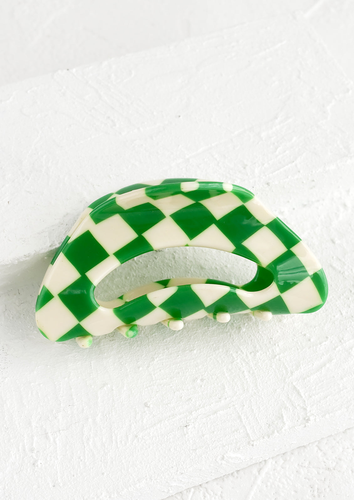 A cloud shaped hair claw in green and white checker print.
