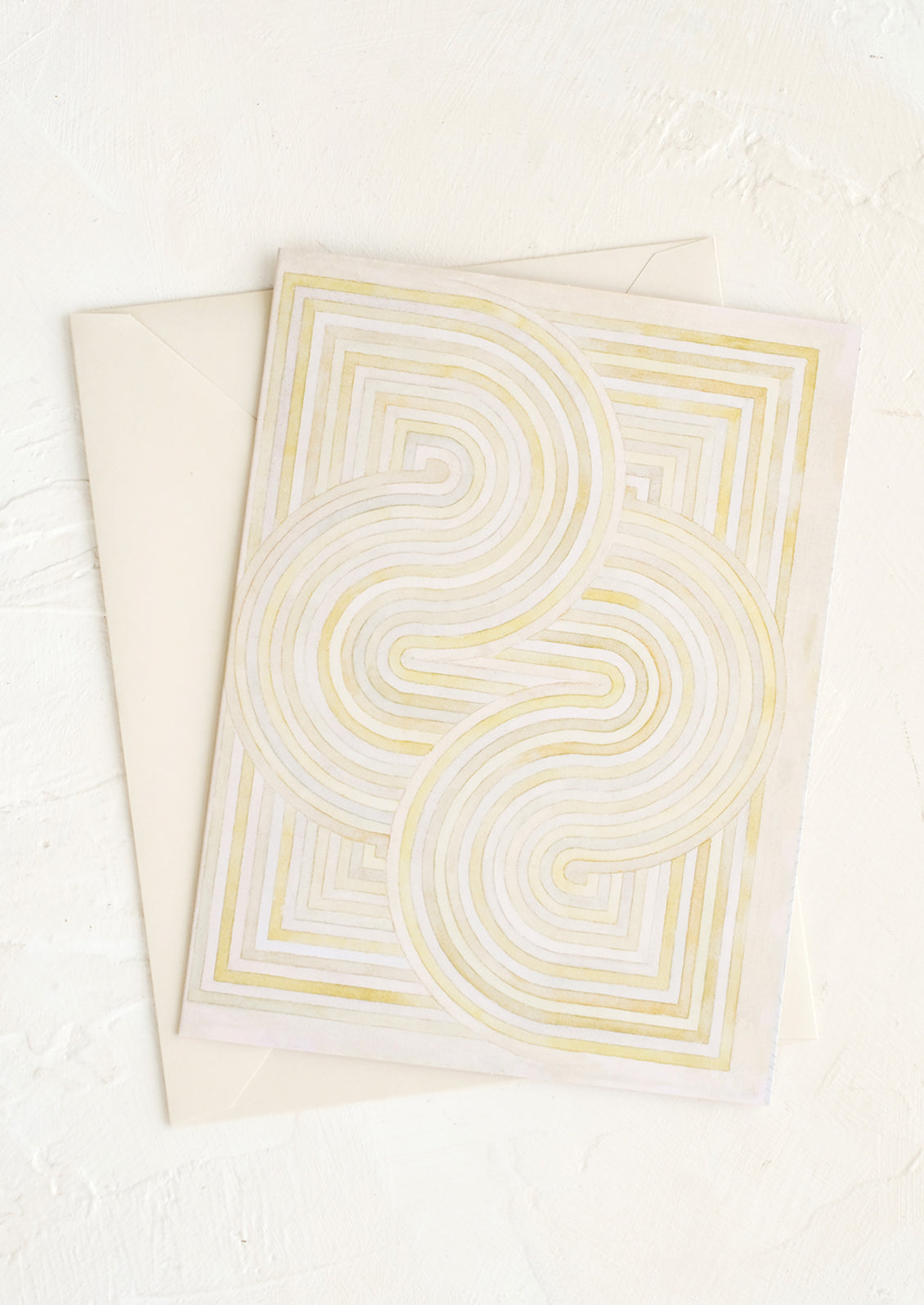 A notecard with pastel geometric artwork design.