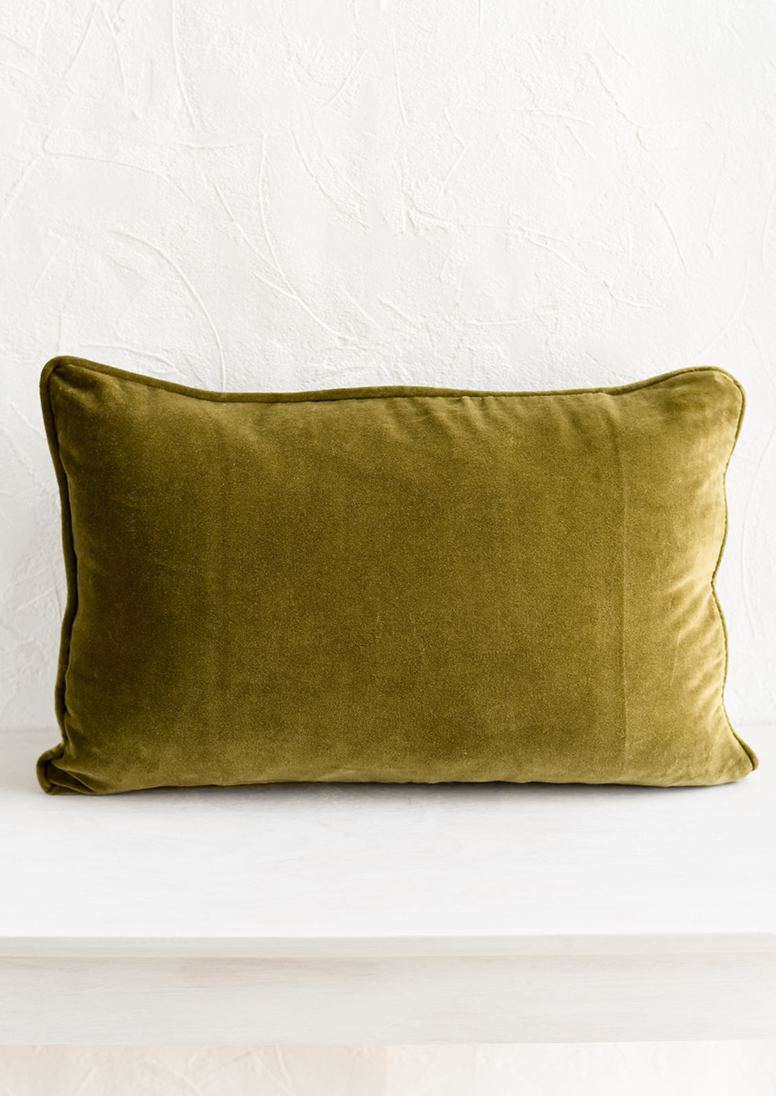 A lumbar velvet throw pillow in khaki green.