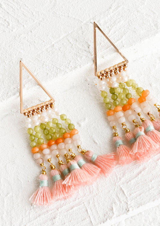 A pair of beaded earrings with tassel detail and triangle base.