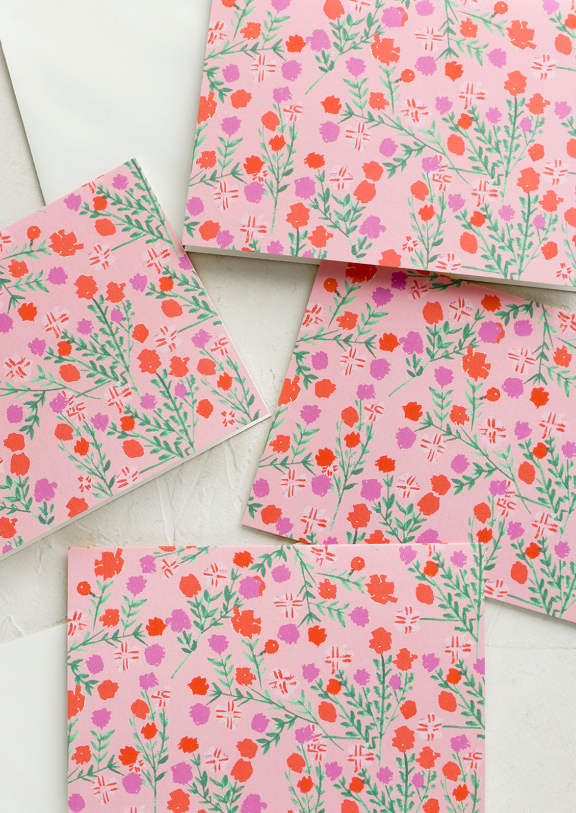 A set of pink cards with floral pattern.