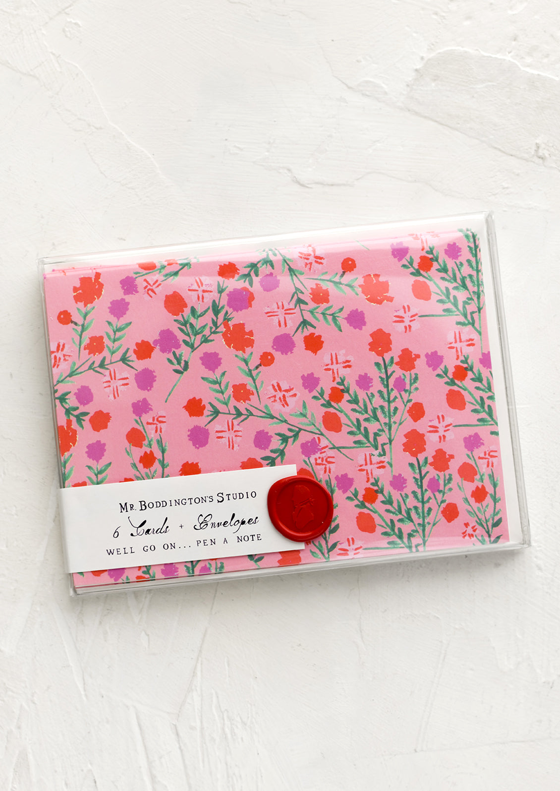 A set of pink cards with floral pattern in wax sealed packaging.