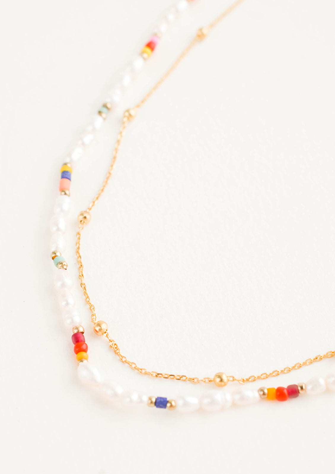Double necklace strand with beaded pearl strand and delicate golden chain strand