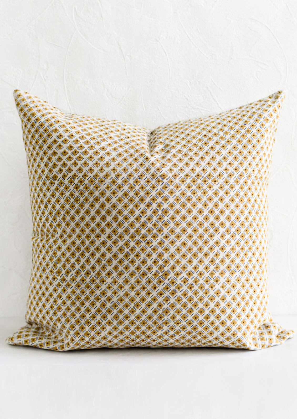 A block printed pillow in small scale floral print.