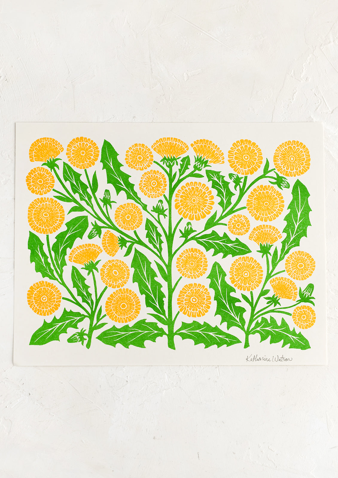 A risograph print of yellow and green dandelion block print design.