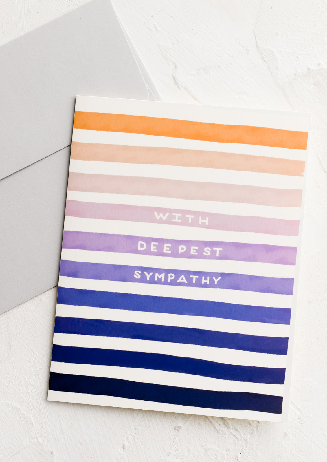 A striped greeting card reading "With deepest sympathy".