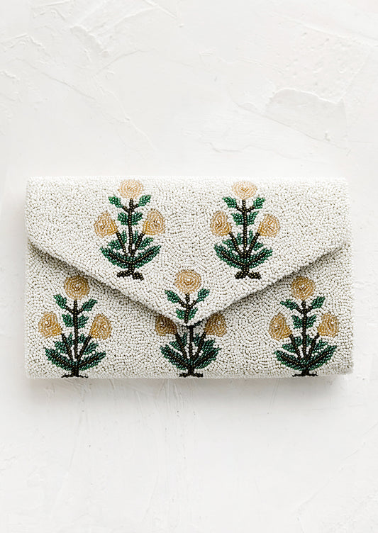 A beaded clutch in floral pattern and envelope silhouette.