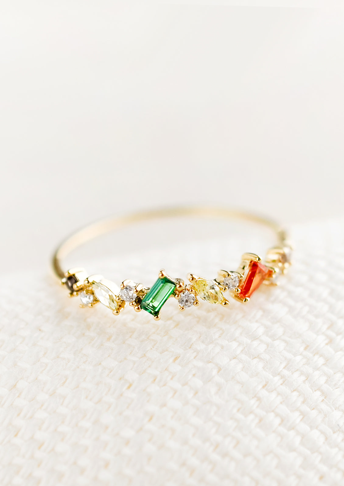 A ring with a mix of crystals in different shapes and colors.