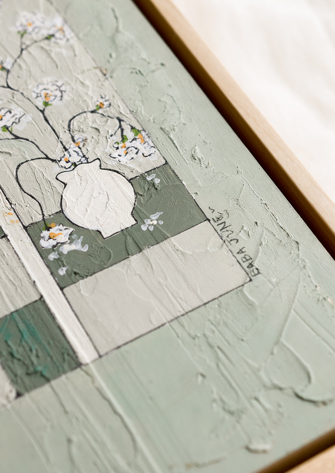 An original painting with paneled still life scene in green.