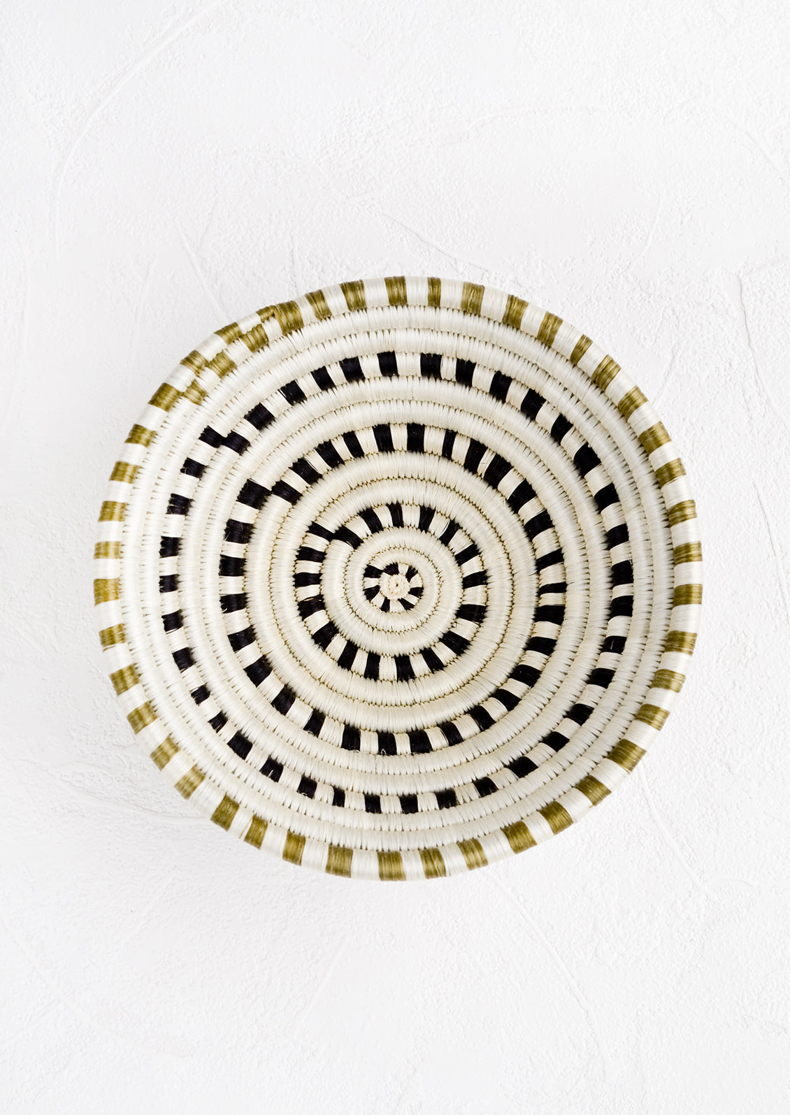 A sweetgrass basket in black and white dash pattern.