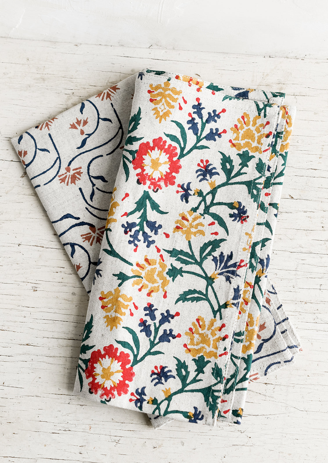 A linen napkin with primary color floral print.