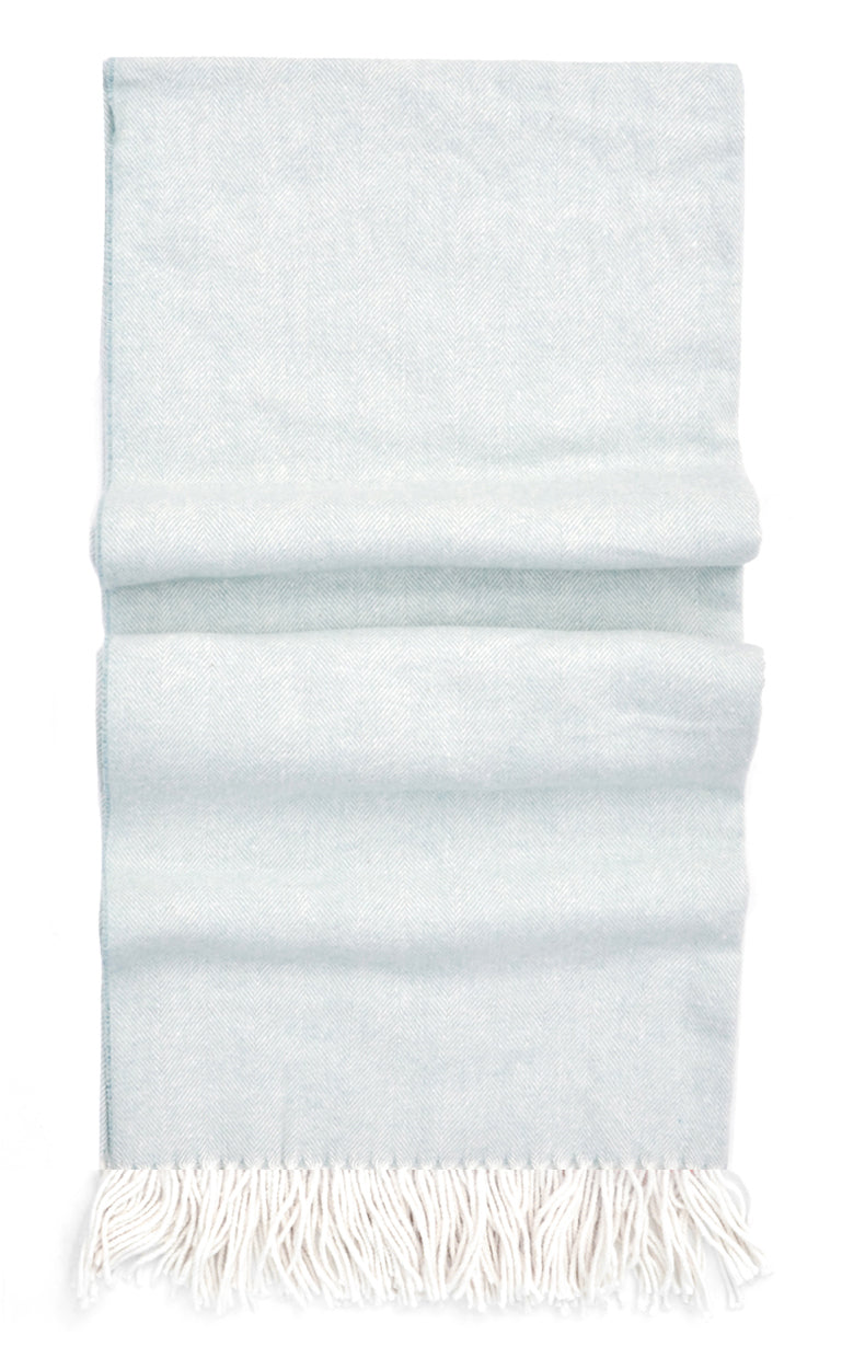 Ice blue throw blanket in fine herringbone weave and ivory tassel trim