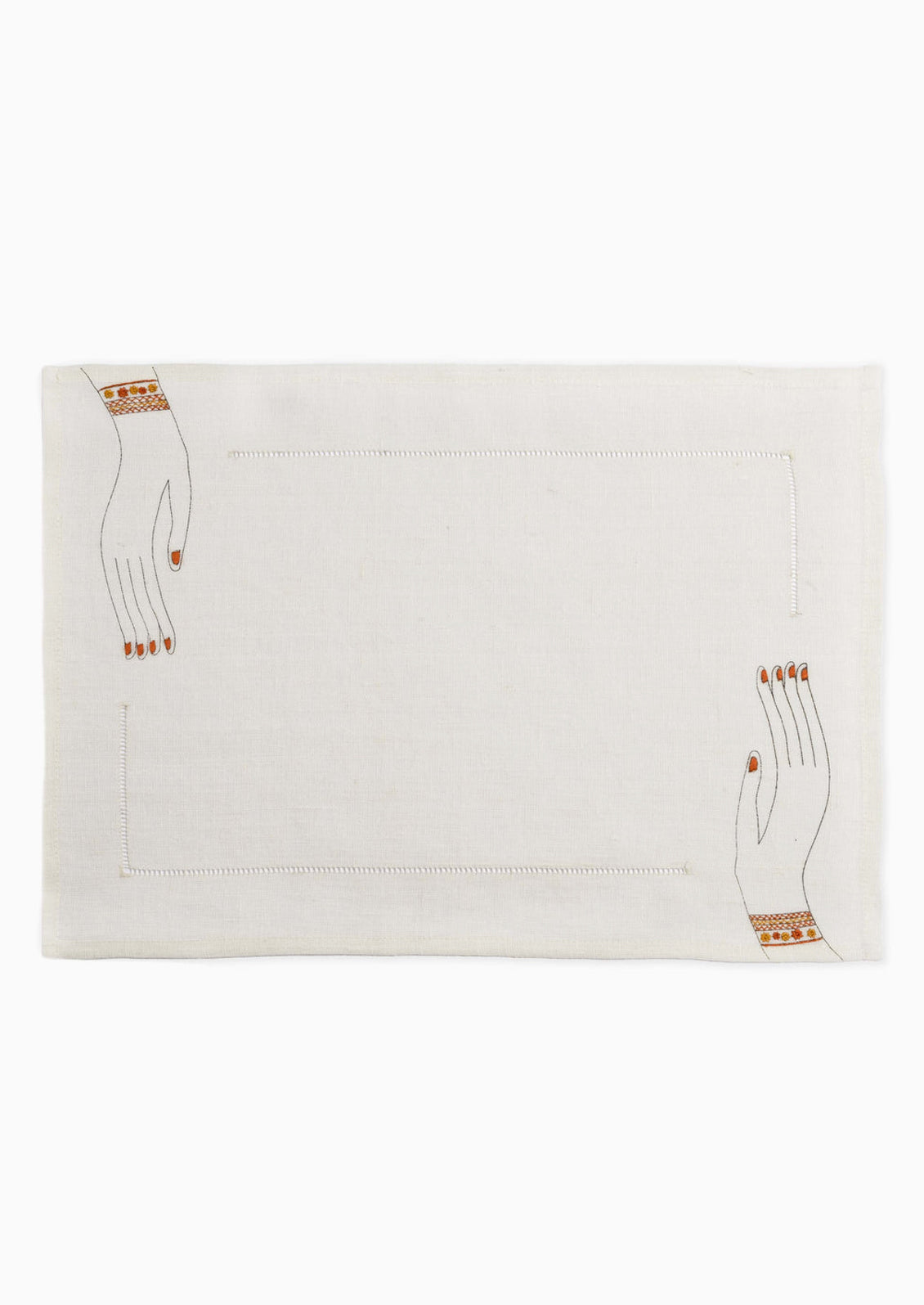 A white linen placemat with hemstitch border and embroidered hands at two corners.
