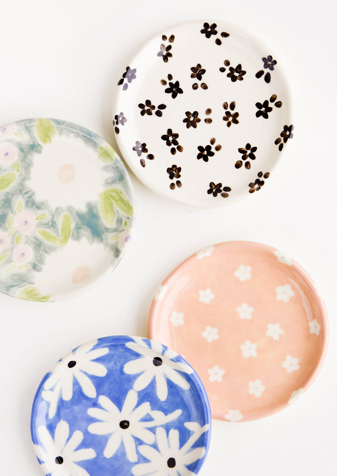 Round ceramic jewelry dishes in a mix of floral patterns