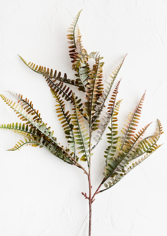 A decorative faux fern frond spray.