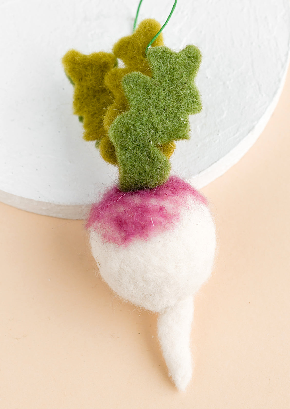 A felted veggie ornament of a turnip.