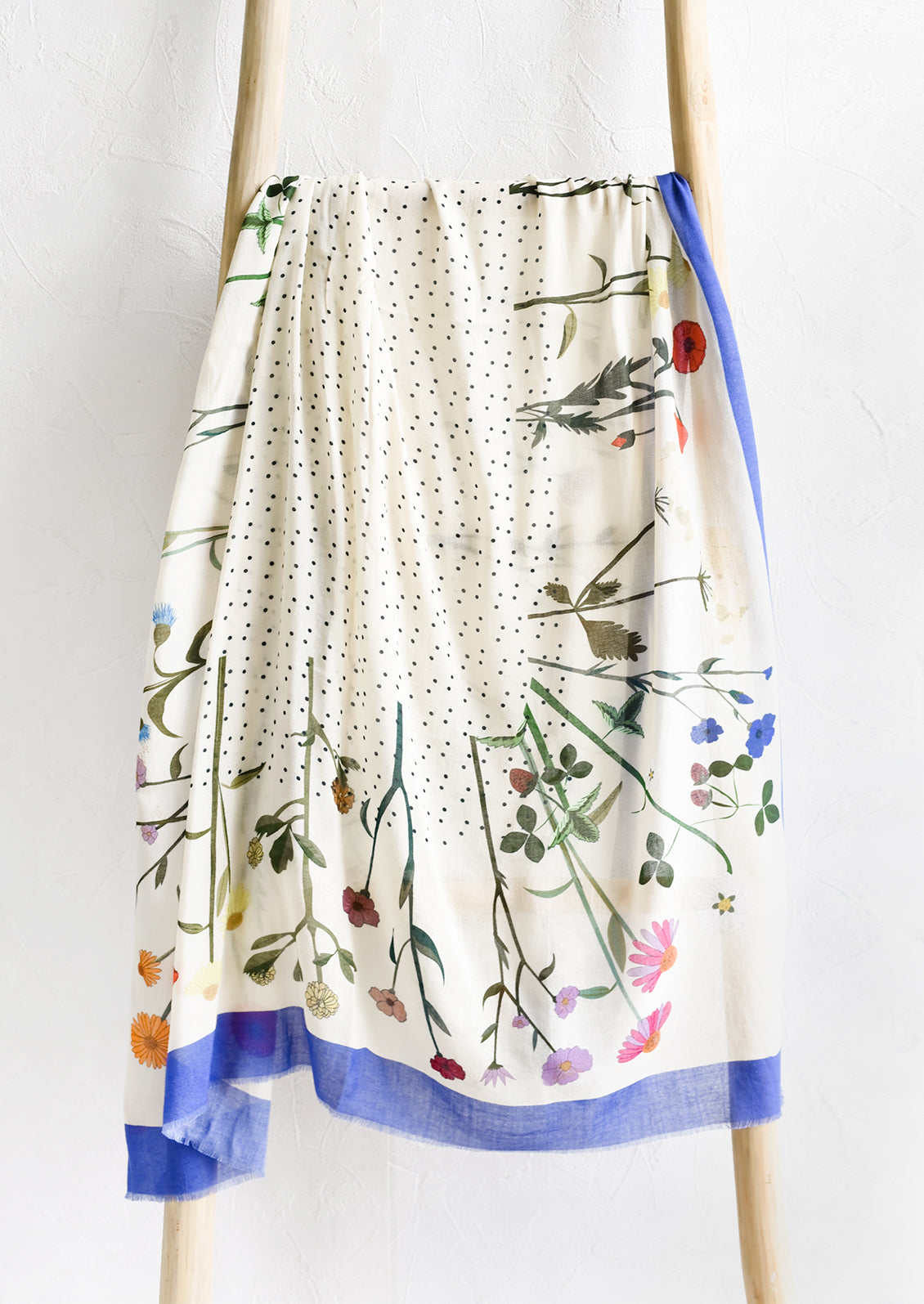 A floral printed scarf with flower border and dotted middle.