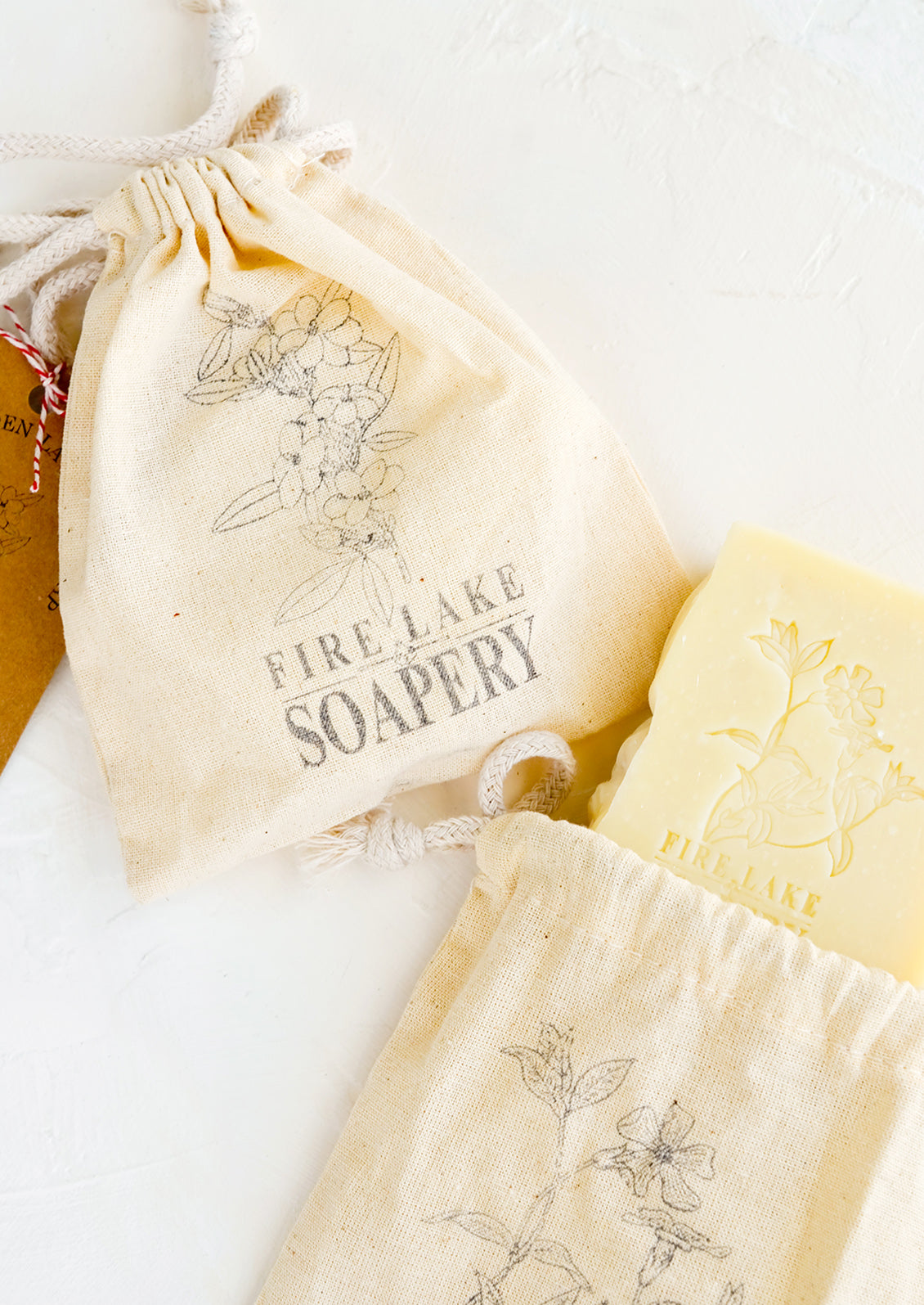 Floral stamped muslin bags containing bar soap.