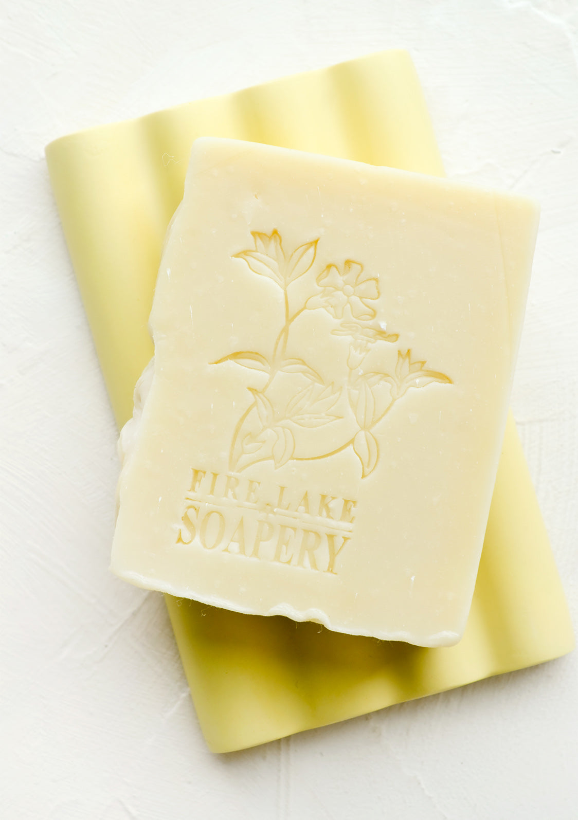 A handmade bar of soap with flower imprint design.