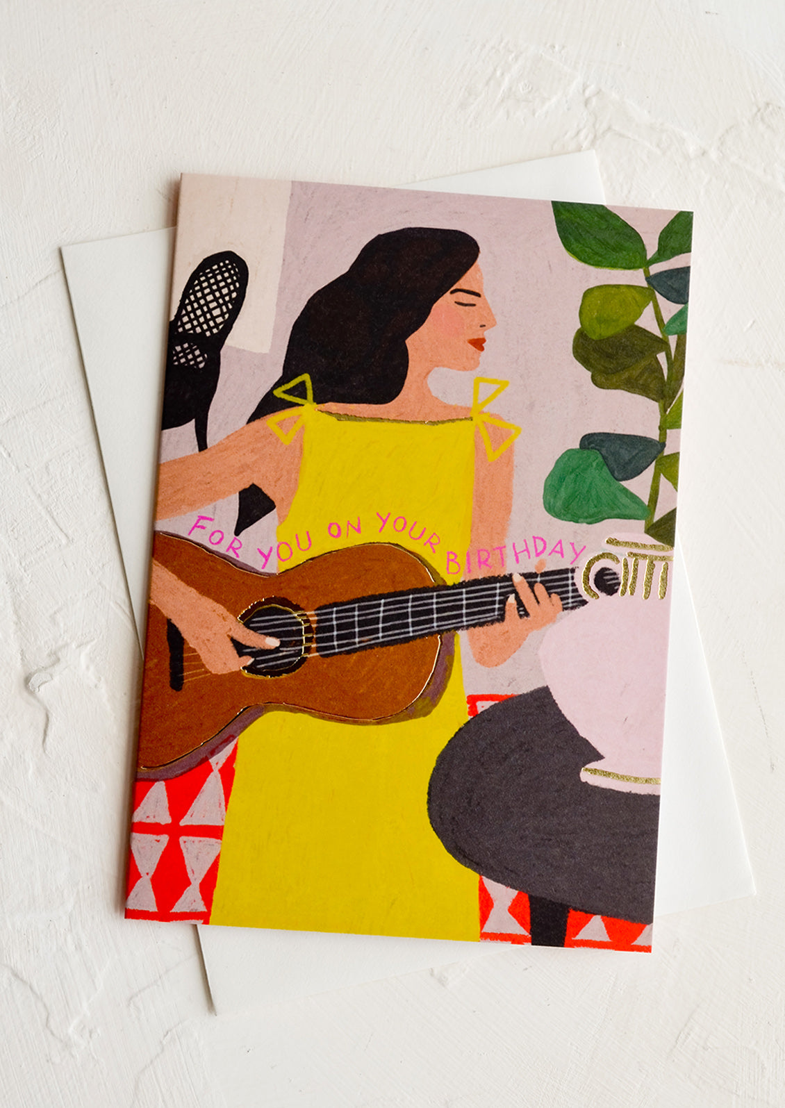 A greeting card with image of woman playing guitar, text reads "for you on your birthday".