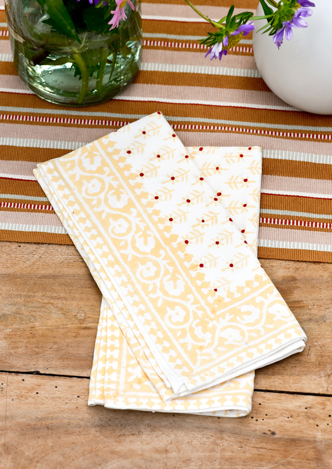 A pair of napkins on a table.