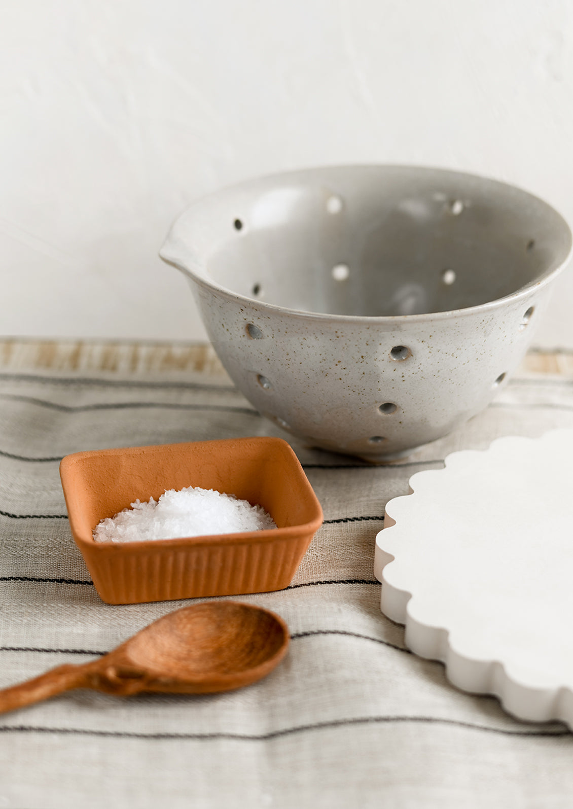 A petrol ceramic stoneware colander.