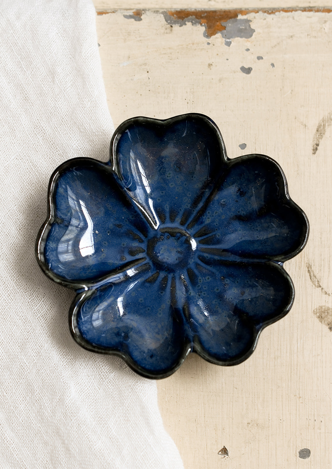A flower shaped trinket dish in indigo.