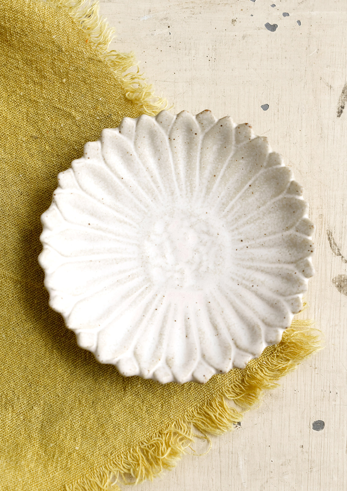 A flower shaped trinket dish in white.