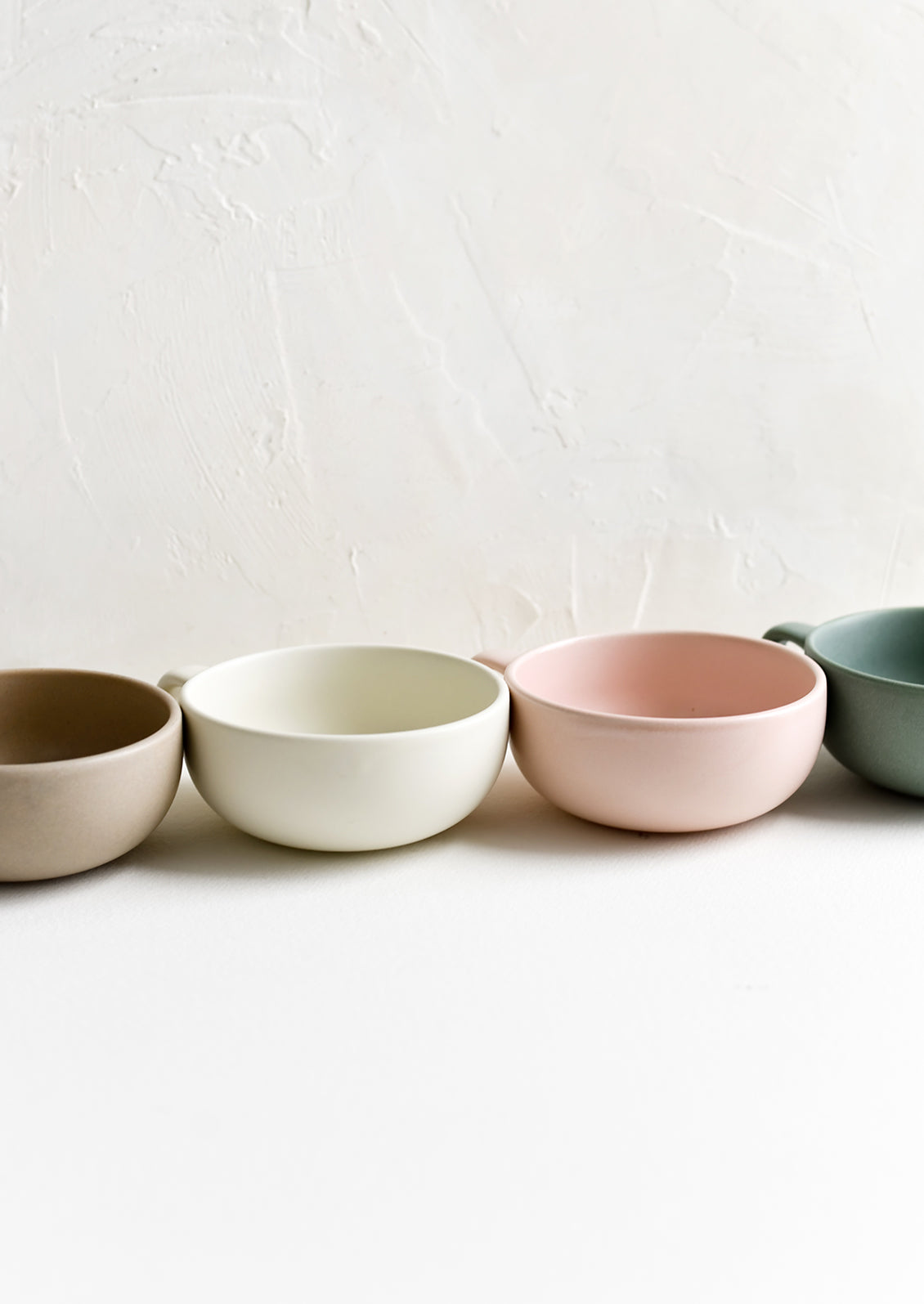 Assorted colors of ceramic mug bowls.