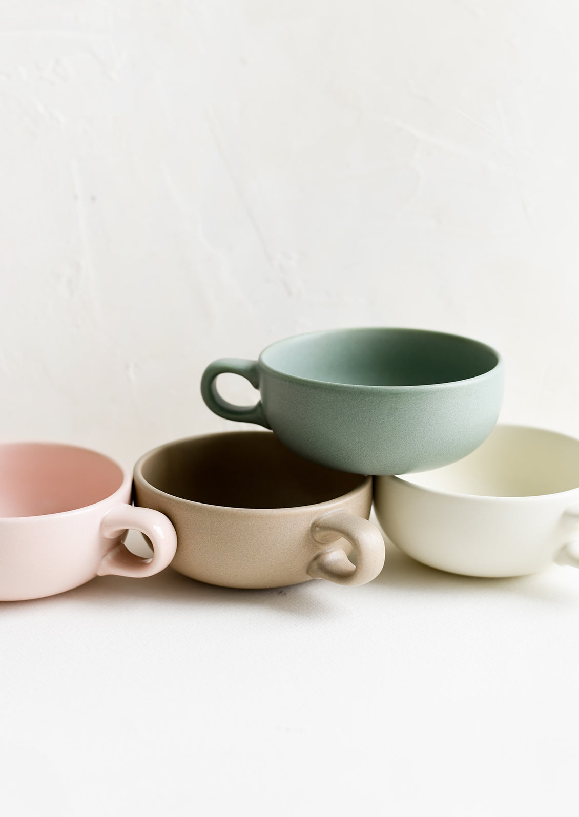Assorted colors of ceramic mug bowls.