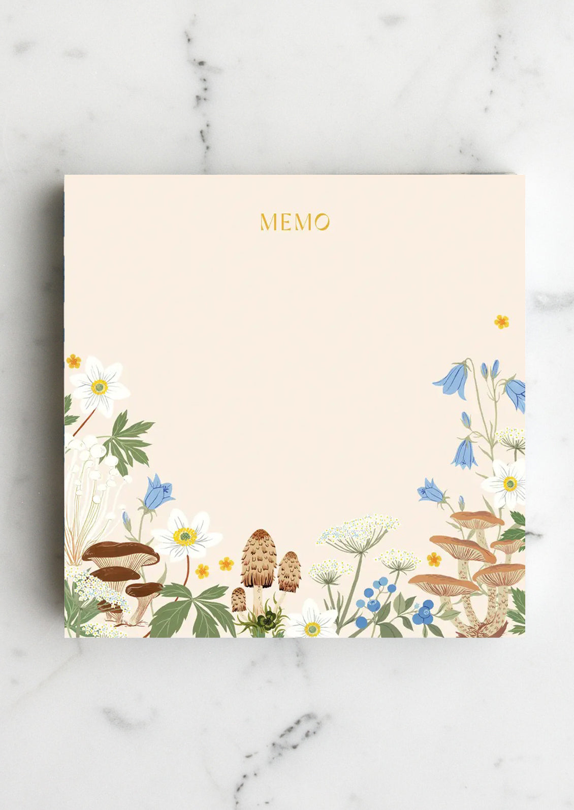 A chunky square notepad reading "MEMO" at top with mushroom floral print at bottom.