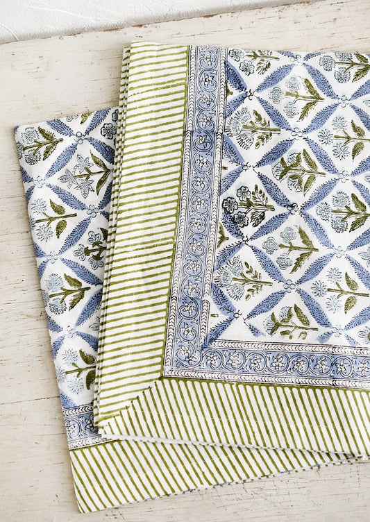 A block printed floral tablecloth in blue and green.