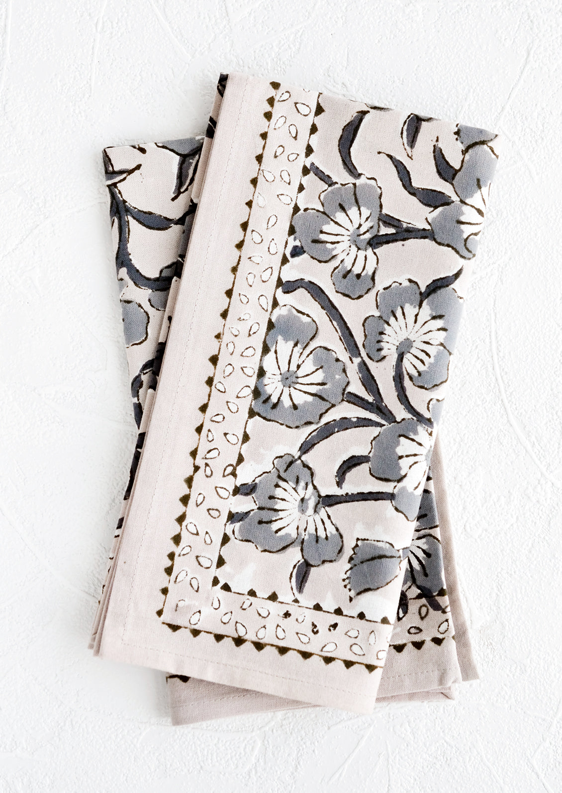 A pair of block printed napkins in purple-grey color with bordered floral pattern.