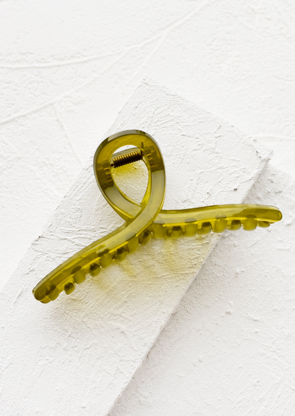 A french twist acrylic hair clip in olive.