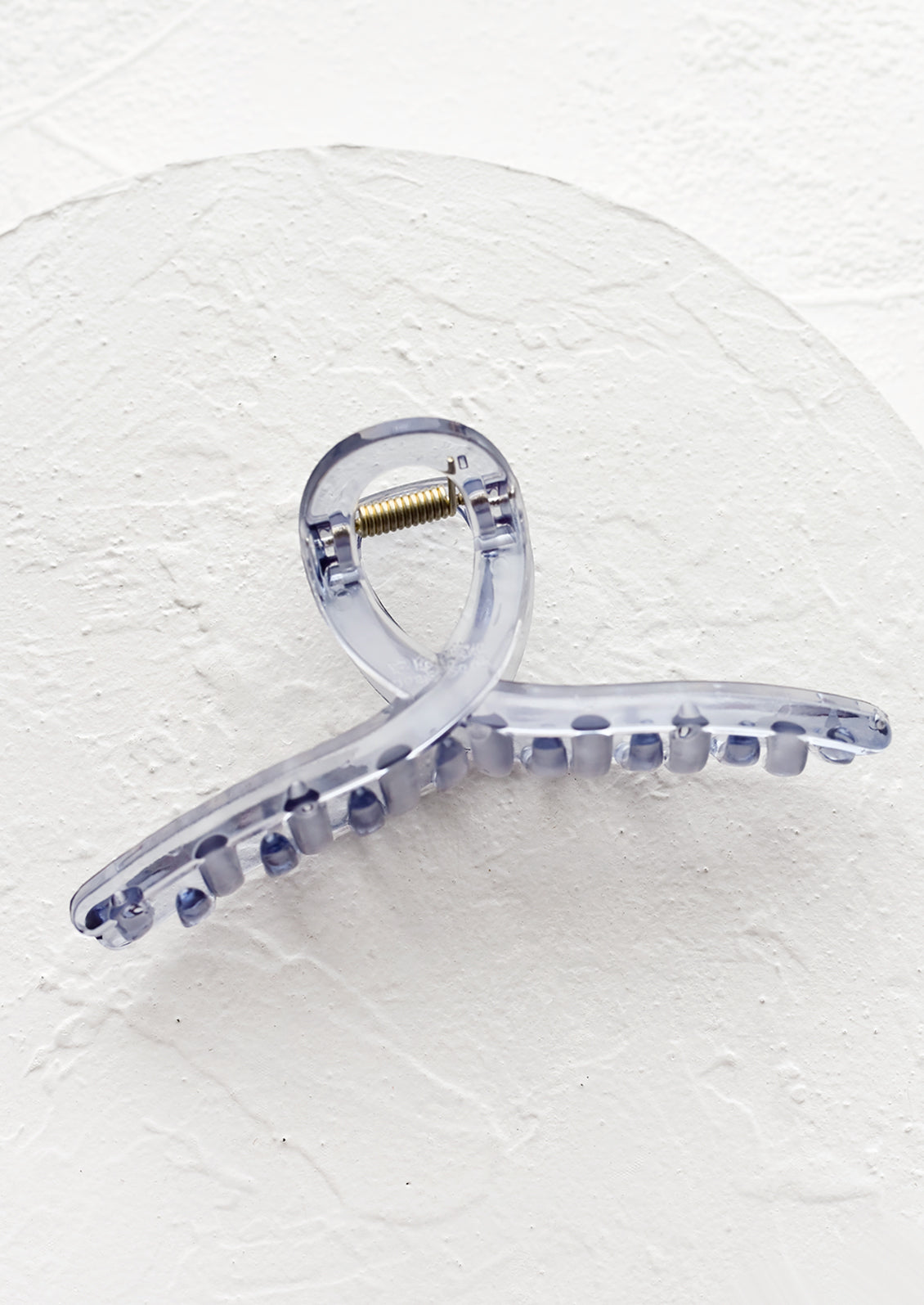 A french twist acrylic hair clip in blue.
