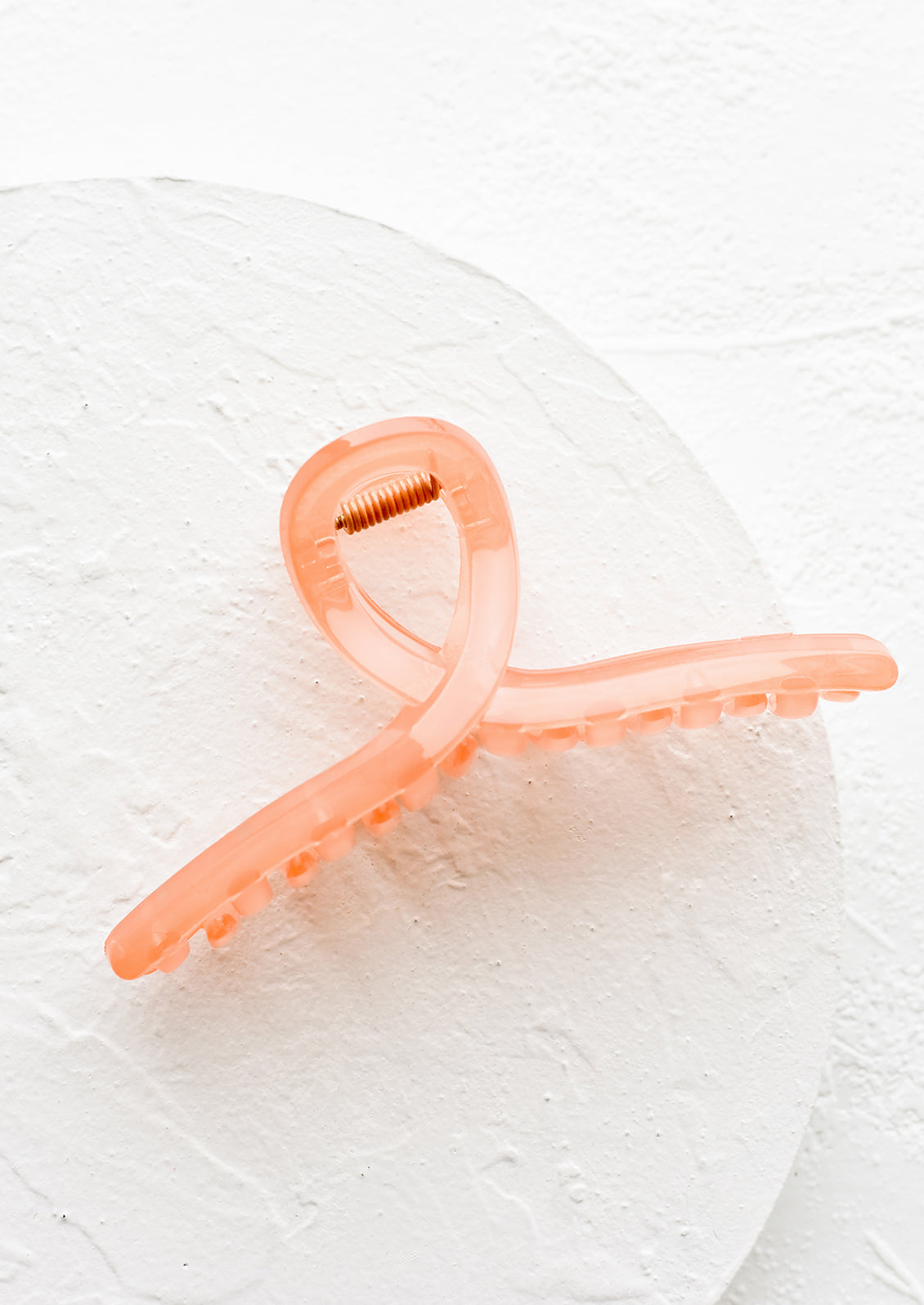 A french twist acrylic hair clip in guava.