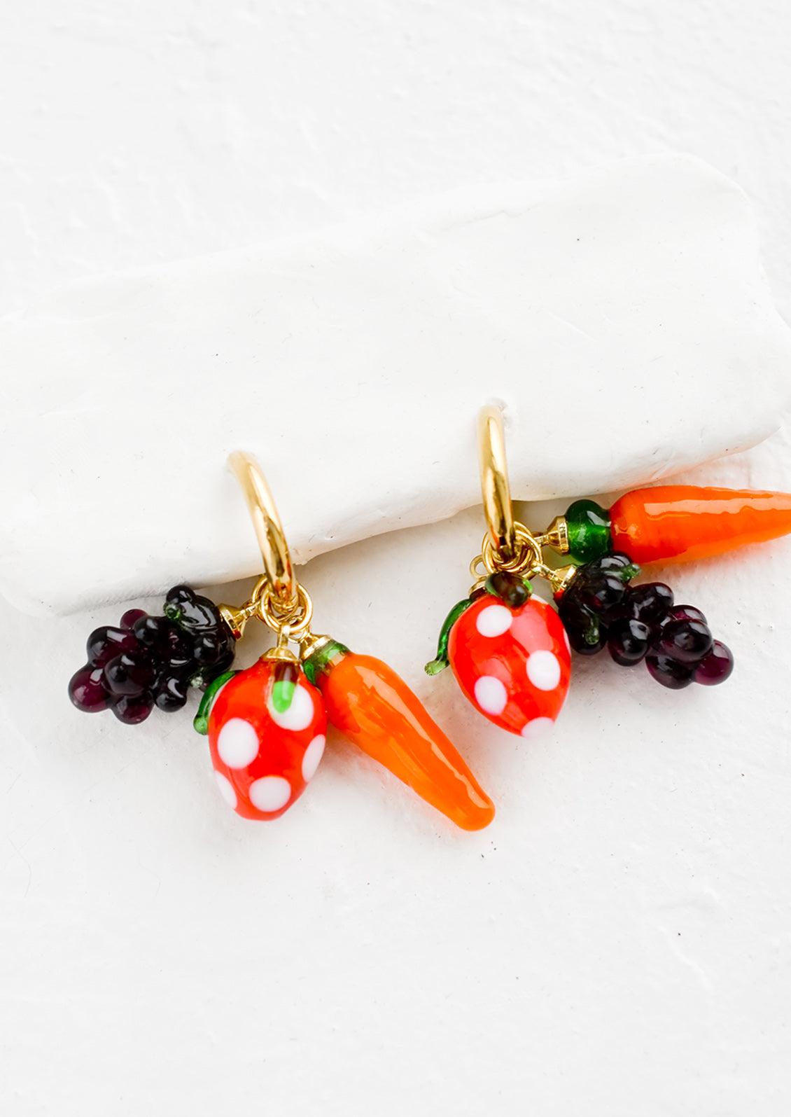 Gold hoop earrings with glass fruit and veggie charms.