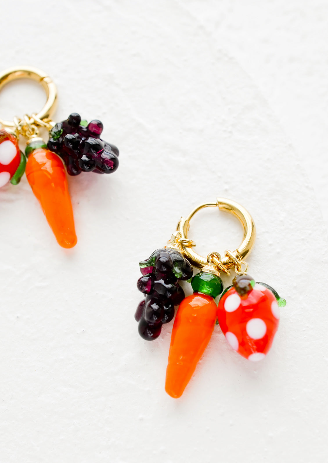 Gold hoop earrings with grape, carrot and strawberry charms.